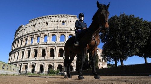An Italian mounted police officer is seen in front of the Colosseum, as the spread of the ...