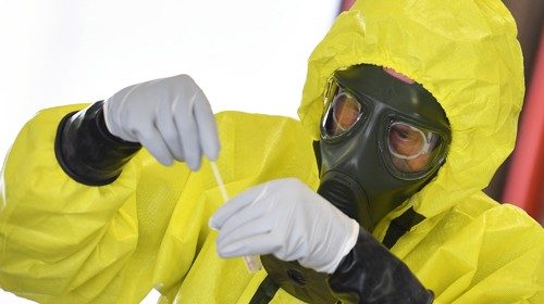 An army medic wearing Personal protective equipment (PPE) takes samples to test soliders of the 3rd ... An army medic wearing Personal protective equipment (PPE) takes samples to test soliders of the 3rd ...