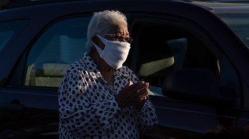 Minnie Madrid, 89, participates in prayer outside the Basilica of San Albino on May 2, 2020 in ...