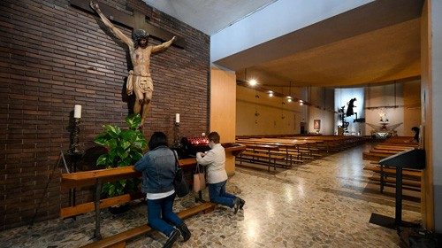 Two women pray at the San Antonio de Padua church in Tarragona on May 11, 2020 as Spain moved ...