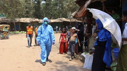 FILE - In this April 15, 2020, file photo, a health worker from an aid organization walks wearing a ...