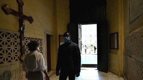 People enter to pray in Rome's Santa Maria in Trastevere church on May 3, 2020  during the country's ...