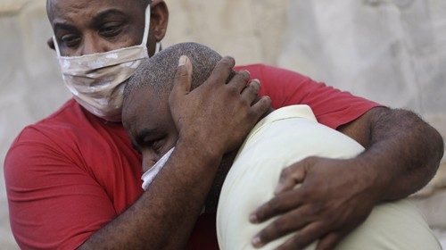 Neilton Pinto (R), wearing a face mask due to the global outbreak of the coronavirus disease ...