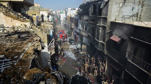 TOPSHOT - Rescue workers gather at the site after a Pakistan International Airlines aircraft crashed ... TOPSHOT - Rescue workers gather at the site after a Pakistan International Airlines aircraft crashed ...