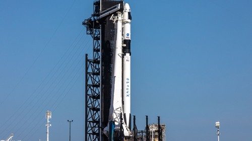 A SpaceX Falcon 9 rocket, with the Crew Dragon atop, stands poised for launch at historic Launch ...
