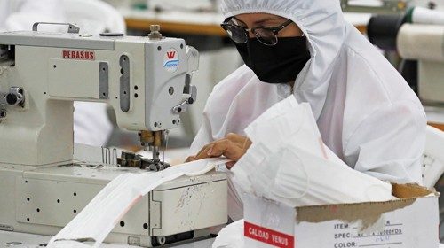 epa08450104 A worker at children's clothing company Bareketex making protective face masks in ...