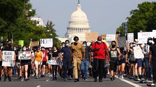 WASHINGTON, DC - JUNE 03: Demonstrators march down Pennsylvania Avenue near the Trump International ...