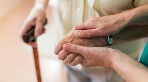 Nurse consoling her elderly patient by holding her handskk.jpg Nurse consoling her elderly patient by holding her handskk.jpg