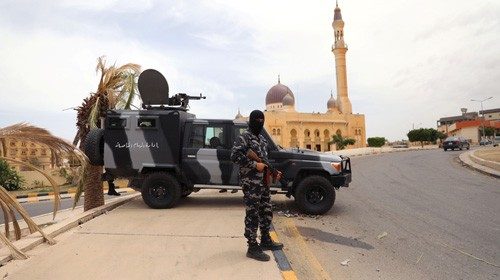 A member of security forces loyal to Libya's internationally recognised government holds a weapon ...