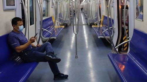 A man wearing a face mask rides the subway, following new cases of the coronavirus disease ...