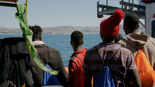 Migrants are seen on board the German NGO search and rescue ship Sea-Watch 3 as the ship navigates ...