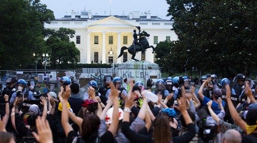 epaselect epa08503104 Protesters put their hands in the air as police clear out Lafayette Park ...