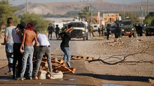 Palestinian protesters clash with Israeli security forces during a rally against Israel's West Bank ...