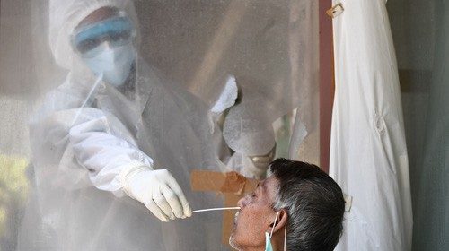 TOPSHOT - In this photograph taken on June 16, 2020, a health official collects a swab sample from a ... TOPSHOT - In this photograph taken on June 16, 2020, a health official collects a swab sample from a ...