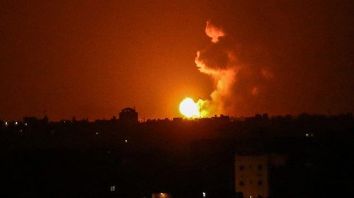 A ball of fire is seen following an Israel airstrike at Khan Yunis in the southern Gaza Strip early ...