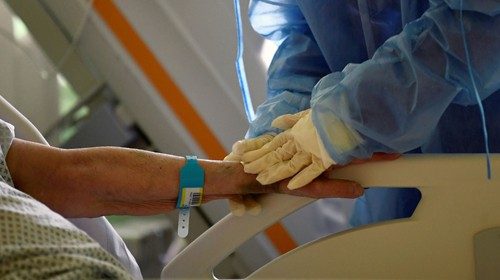 FILE PHOTO: Member of the medical staff in protective suit treats a patient suffering from ...