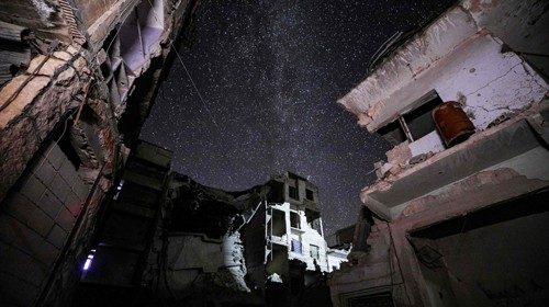 This long-exposure picture taken early on June 27, 2020 shows a view of buildings destroyed by prior ...