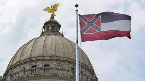 A Mississippi flag flies at the State Capitol hours before Governor Tate Reeves signs a bill into ...