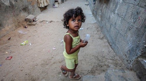 epa08516779 A Palestinian girl play next to her family house, in Khan Younis refugee camp in the ...