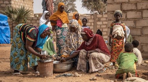 (FILES) In this file photo taken on January 22, 2020 Women and children stand outside an ...