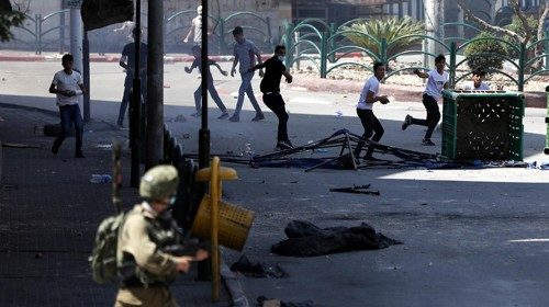epa08529175 Palestinian protesters clash with Israeli soldiers during a protest in the West Bank ...