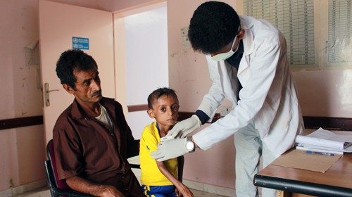 A doctor checks malnourished boy Hassan Merzam Muhammad, at a hospital in Aslam district of Hajjah ...