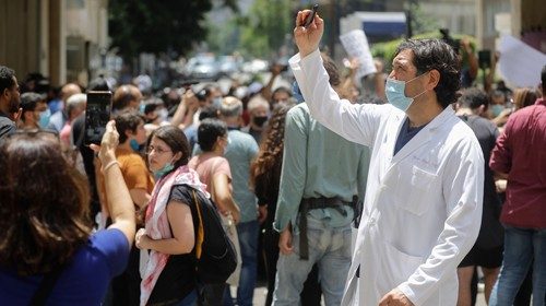 A Lebanese physician takes photos as former employees of the American University Medical Center ... A Lebanese physician takes photos as former employees of the American University Medical Center ...