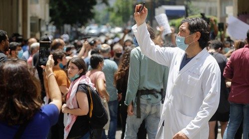 A Lebanese physician takes photos as former employees of the American University Medical Center ...