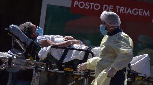 epa08563381 A woman is moved to an ambulance outside Asa Norte Hospital (Hospital Regional da Asa ...