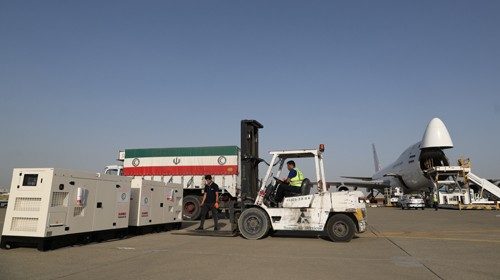 Cargo personnel work at a loading operation of Iran's humanitarian aid to Lebanon after the massive ...