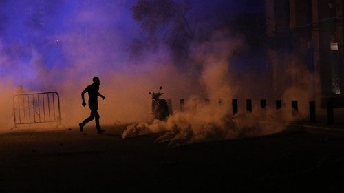 TOPSHOT - An anti-government Lebanese protester, joining thousands of people enraged by a deadly ...