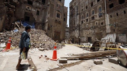 epa08595906 Yemeni workers inspect collapsed UNESCO-listed buildings following torrential rains in ...