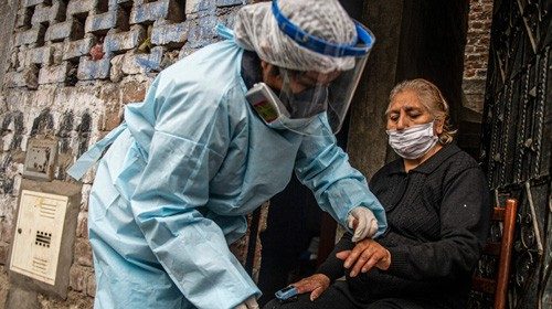 TOPSHOT - A Peruvian Health Ministry worker examines and carries out a test to discard COVID-19 in ...
