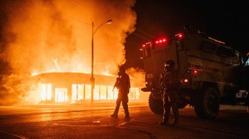 KENOSHA, WI - AUGUST 24: A police armored vehicle patrols an intersection on August 24, 2020 in ...