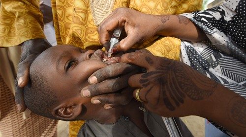 (FILES) In this file photo taken on April 22, 2017 A Health worker administers a vaccine to a child ...