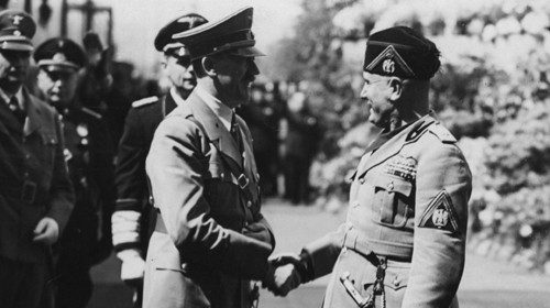 13th April 1938:  Italian fascist leader Benito Mussolini greeting Adolf Hitler upon his arrival in ...