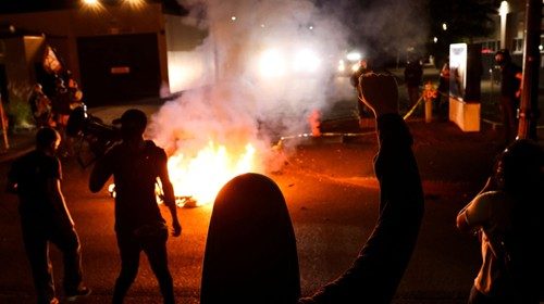 Protesters gather outside the Portland Police Bureau's North Precinct on the 101th consecutive night ...