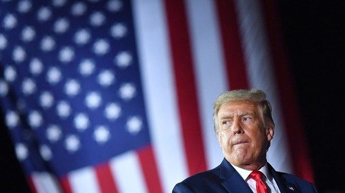 TOPSHOT - US President Donald Trump gestures during a campaign rally at MBS International Airport in ... TOPSHOT - US President Donald Trump gestures during a campaign rally at MBS International Airport in ...