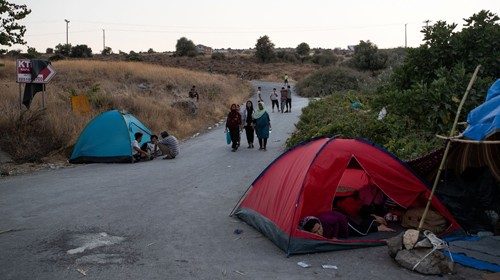 Refugees and migrants from the destroyed Moria camp are seen in tents near a new temporary camp, on ... Refugees and migrants from the destroyed Moria camp are seen in tents near a new temporary camp, on ...