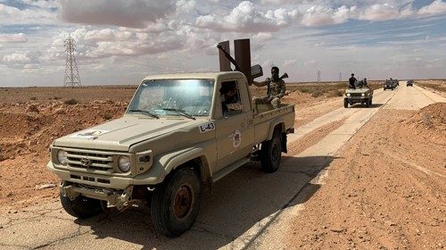 Troops loyal to Libya's internationally recognized government patrol the area in Zamzam, near Abu ...