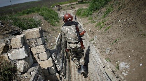 FILE PHOTO: Ethnic Armenian soldiers walk in a trench at their position near Nagorno-Karabakh's ...