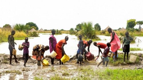 Civilians attempts to block flood water from the broken dykes on the Nile river, in Genyiel county, ...
