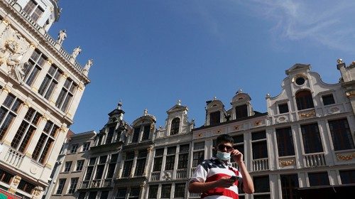 FILE PHOTO: A man wearing a protective mask, that became mandatory in Brussels' public places, walks ...