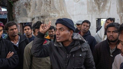 Migrants from Bangladesh stand inside an old abandoned factory near Velika Kladusa, Bosnia and ...