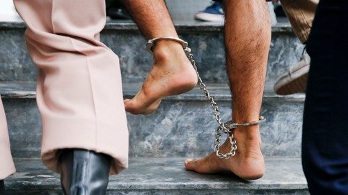 The shackled feet of a bombing suspect in Bangkok, Thailand, are seen as he is escorted by officers ... The shackled feet of a bombing suspect in Bangkok, Thailand, are seen as he is escorted by officers ...