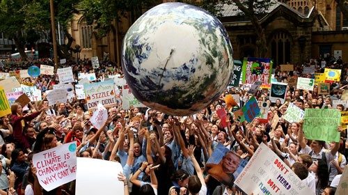 SYDNEY, AUSTRALIA - MARCH 15: An inflatable planet earth is bounced around the crowd during a ...