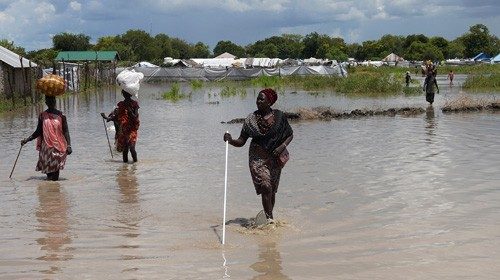 Women wade through flood waters after the River Nile broke the dykes in Pibor, Greater Pibor ... Women wade through flood waters after the River Nile broke the dykes in Pibor, Greater Pibor ...