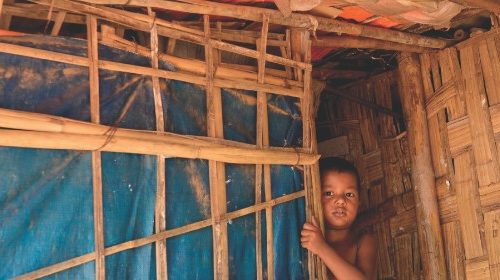A Rohingya refugee child peeps out from his hut in Kutupalong refugee camp in Ukhia on October 11, ...