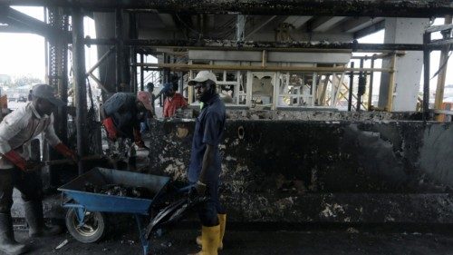 Workers clean up the Lekki toll gate, a site where soldiers had opened fire on protesters late on ...
