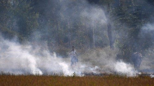 In this photograph taken on October 22, 2020 a man walks through a burning straw stubble on a field ... In this photograph taken on October 22, 2020 a man walks through a burning straw stubble on a field ...